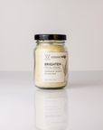 glass jar of facial grains on white background