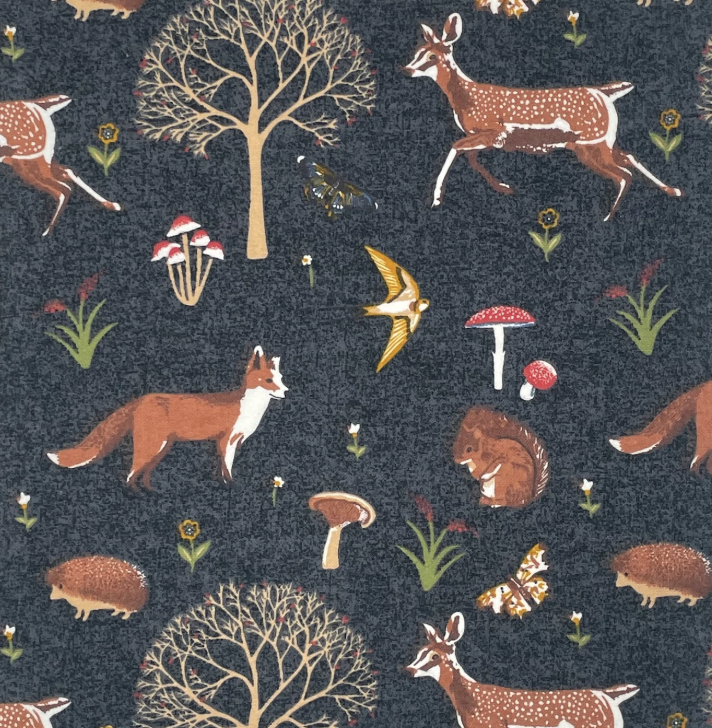 dark grey fabric with trees, mushrooms, butterflies, foxes, flowers and deer. 