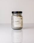 glass jar of facial grains on white backdrop