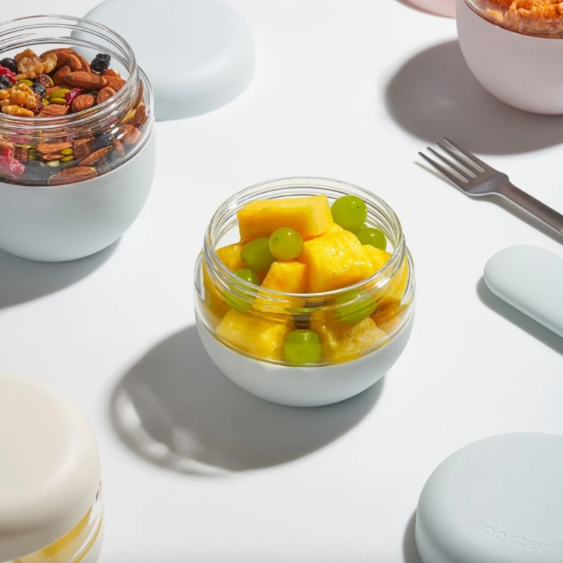 bowl of mango and grapes on white backdrop