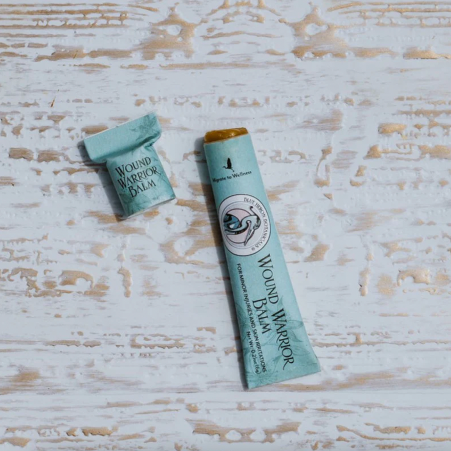 paper tube of wound balm on wood backdrop