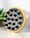 silicone and bamboo head massager on its side